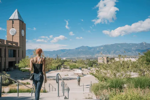 Student on campus looking out at the mountains