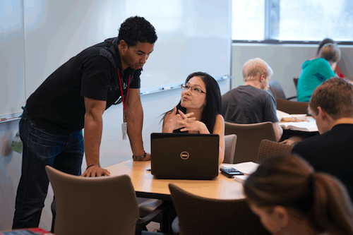 student and faculty looking at computer together